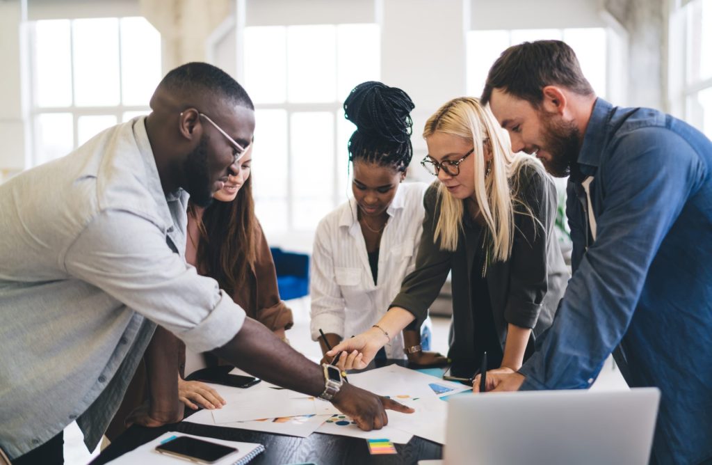 Group of professionals working on a project with documents on the table