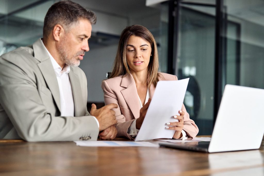 2 professionals in discussion over a contract