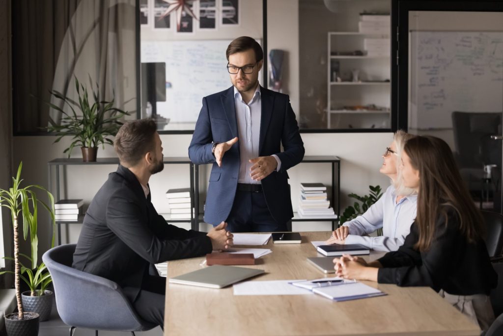 Professional giving a presentation to 2 colleagues